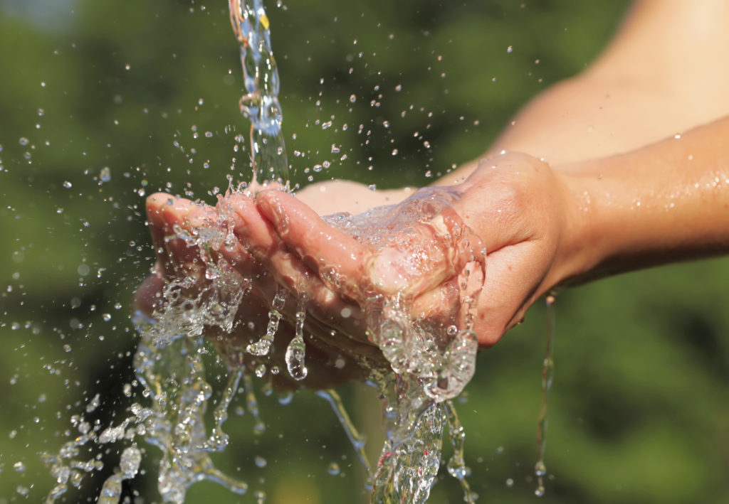 Woman's hands with water splash